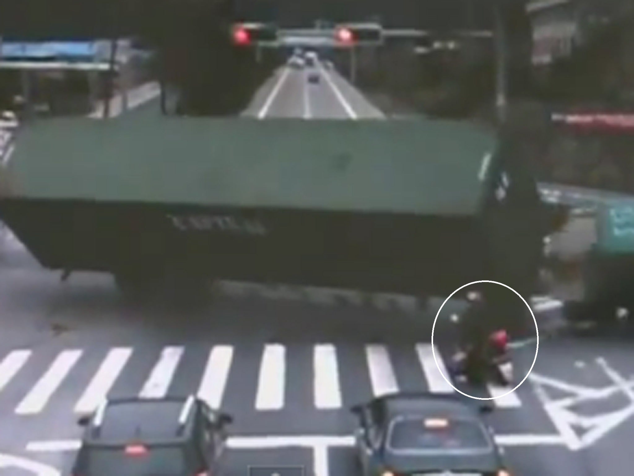 The moment the lorry tips over narrowly missing a motorcyclist