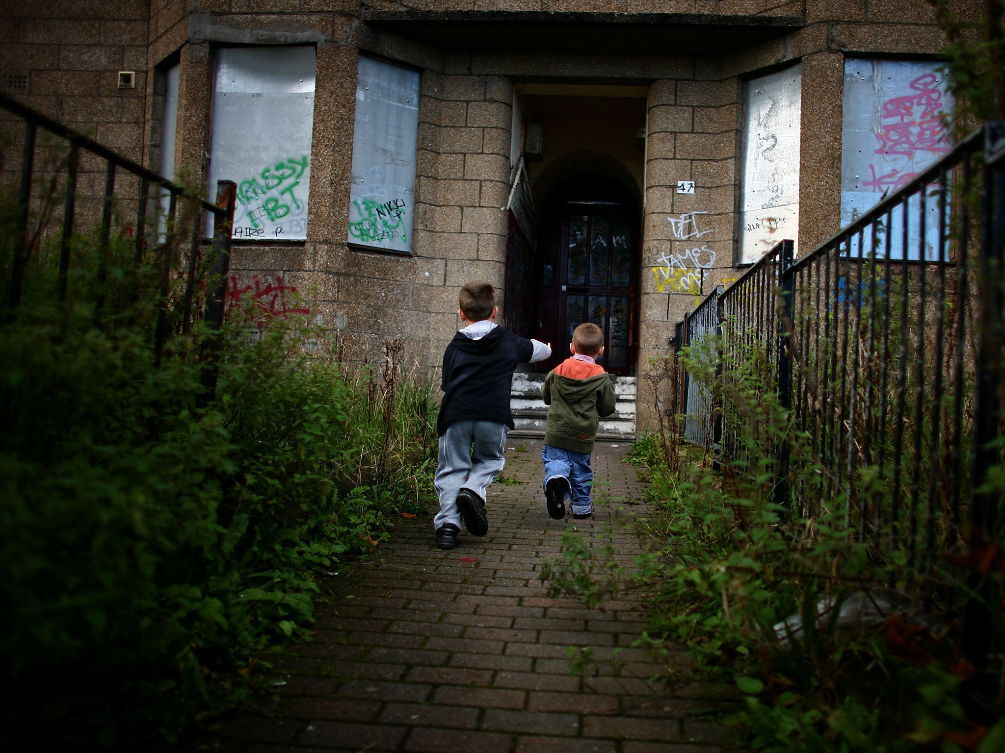Two young boys play in a run down street with boarded up houses, September 30, 2008 in the Govan area of Glasgow, Scotland