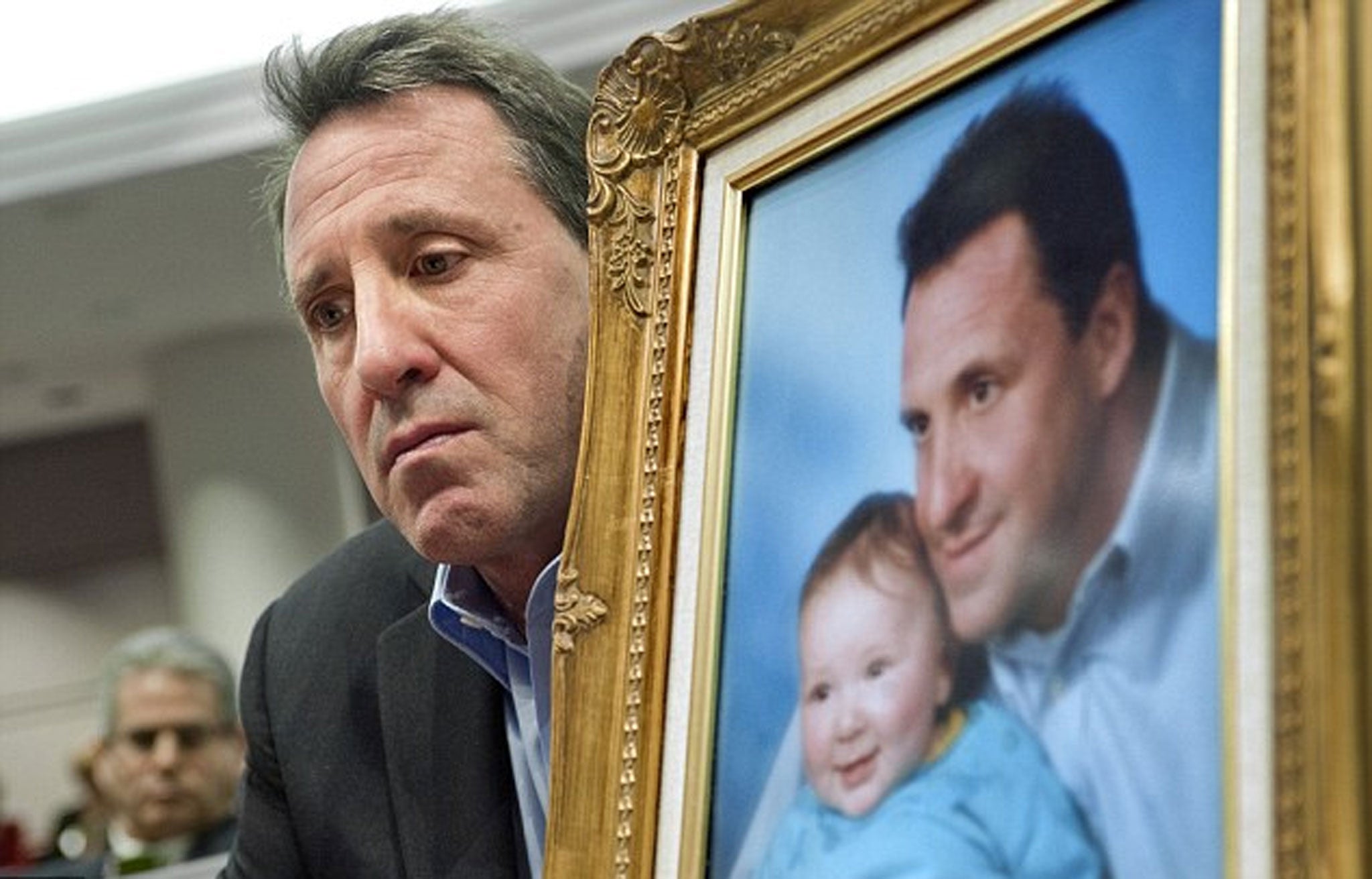 Neil Heslin with a framed photograph of his murdered son Jesse (file photo)