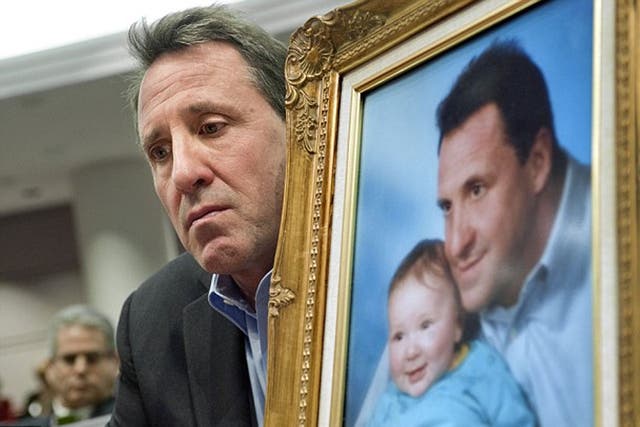 <p>Neil Heslin with a  framed photograph of his murdered son Jesse (file photo) </p>