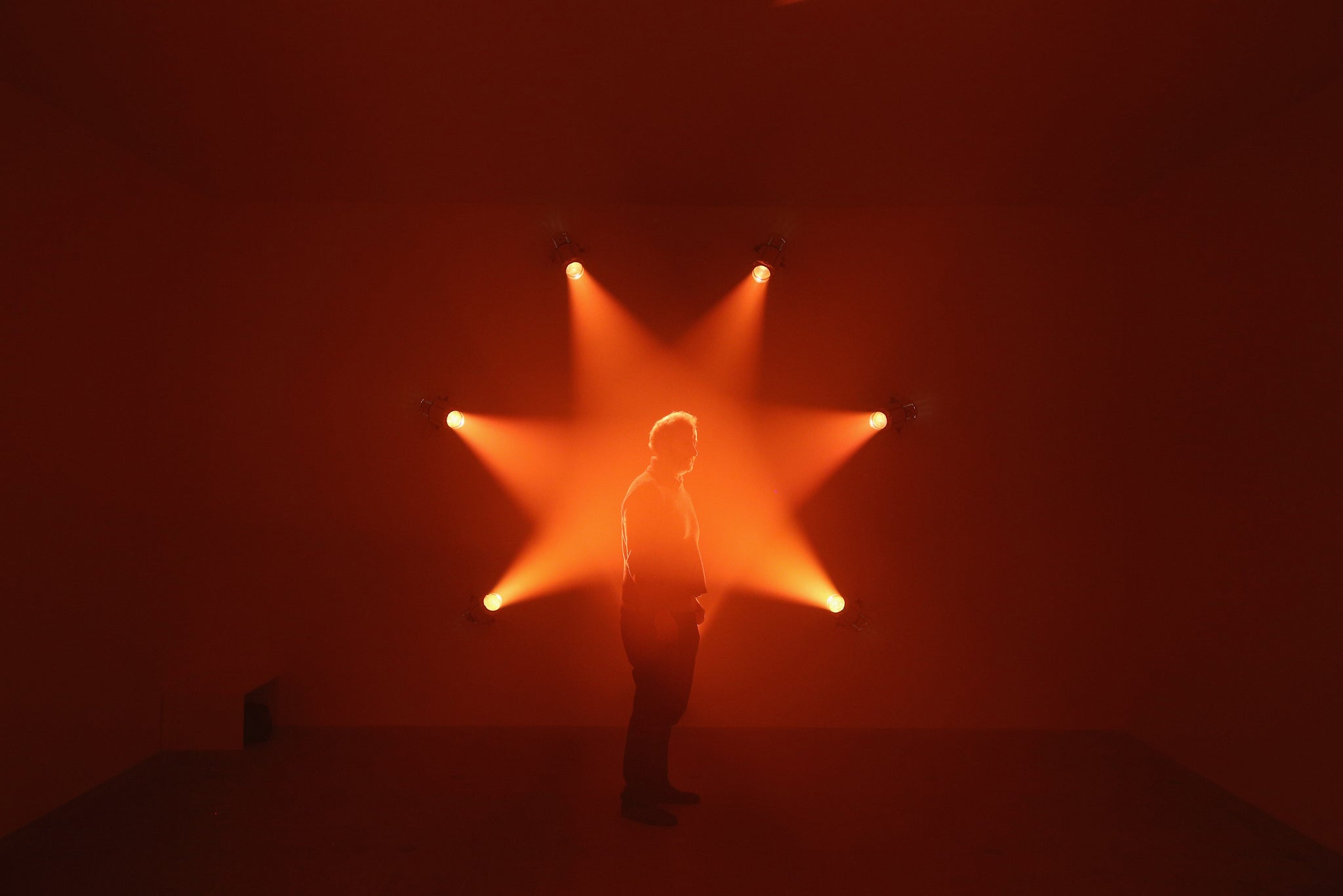 A man admires an art installation by Ann Veronica Janssens entitled 'Rose' which features in the Hayward Gallery's exhibition 'Light Show'