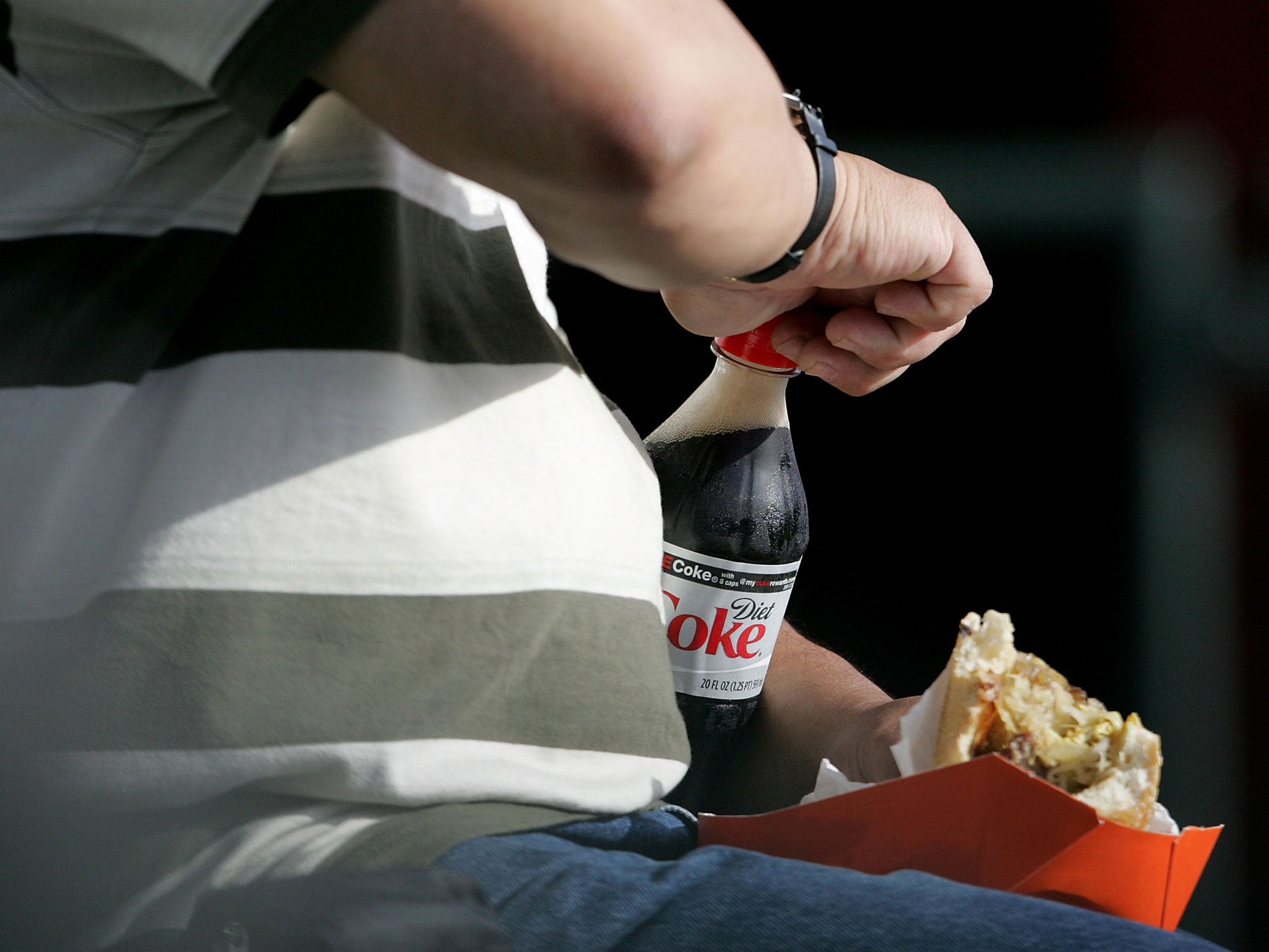 A man who is no doubt confident in his own sexiness opens a bottle of Diet Coke at AT&T Park July 24, 2007 in California.