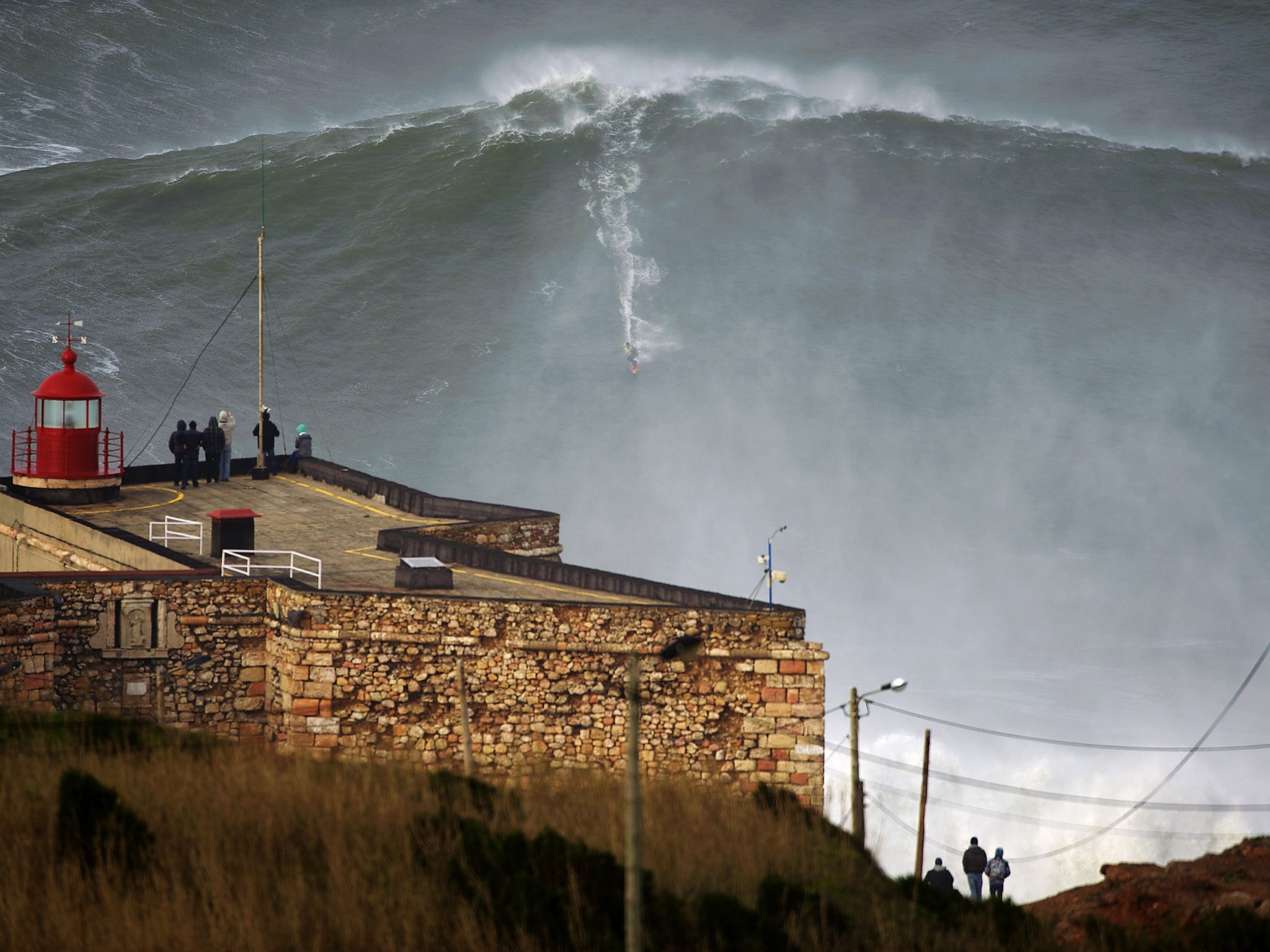 The moment surfer Garrett McNamara rides the wave off the coast of Portugal