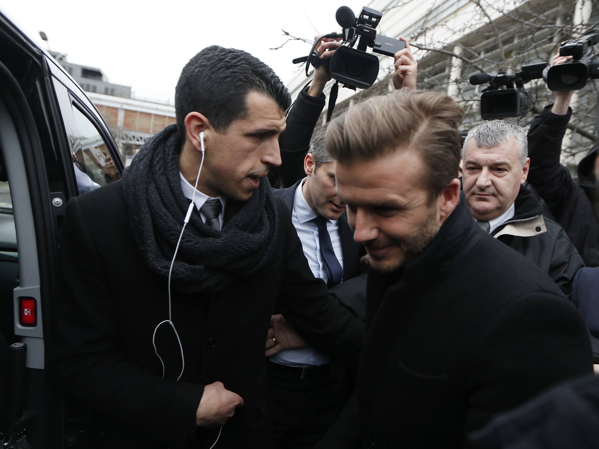 David Beckham is seen at the Pitie-Salpetriere hospital for his medical examination in Paris