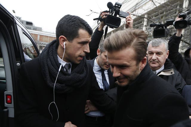 David Beckham is seen at the Pitie-Salpetriere hospital for his medical examination in Paris 