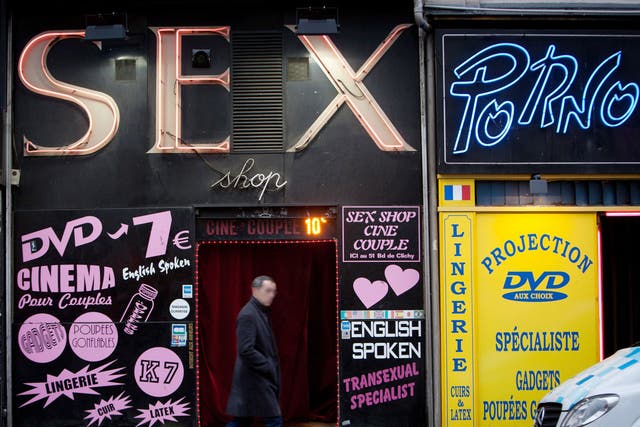 A man walks in front of a sex shop on January 12, 2011 in the Paris district of Pigalle.