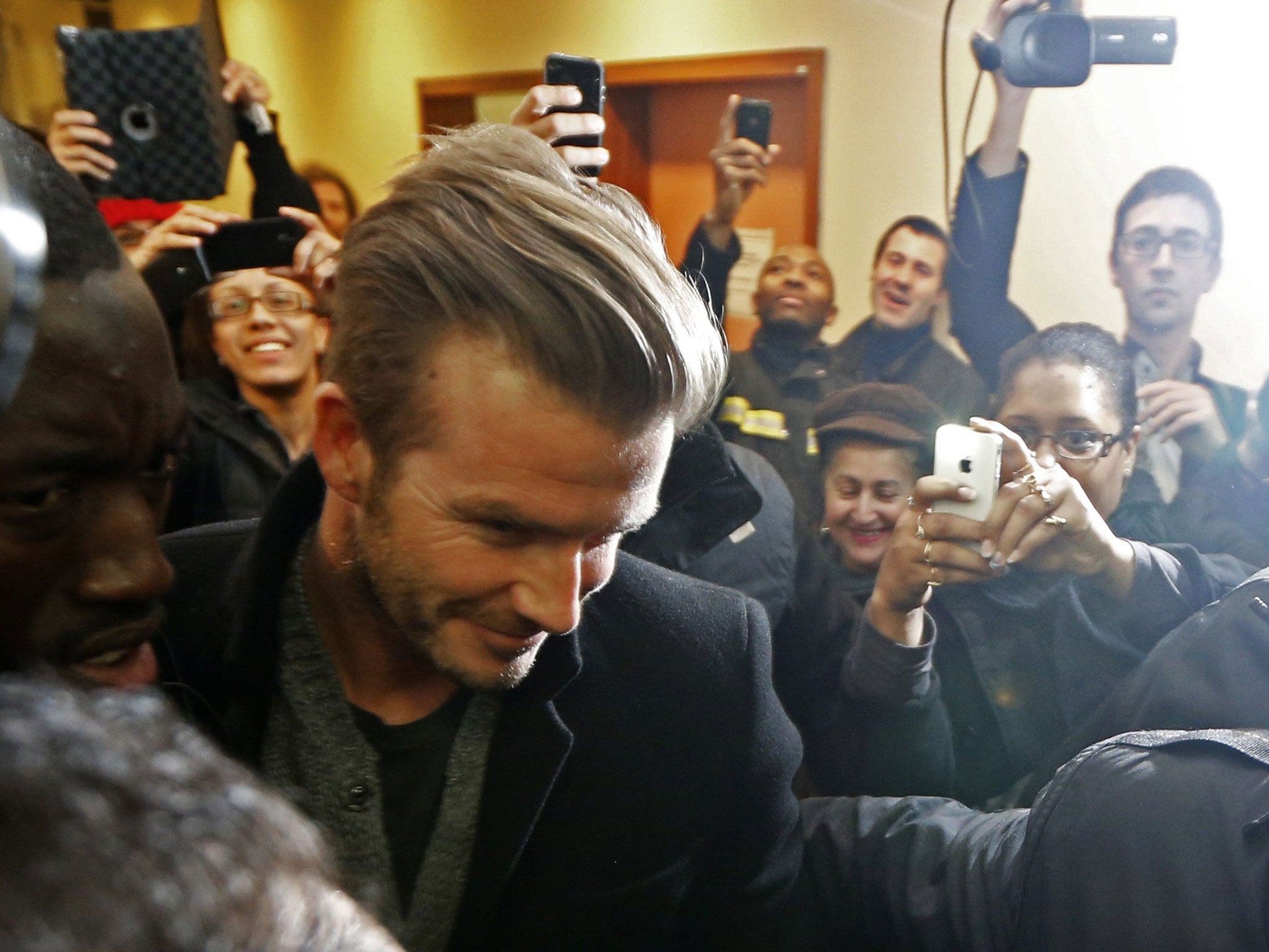 David Beckham is mobbed before his unveiling in Paris