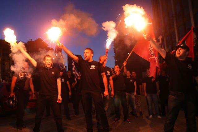 Members of Golden Dawn demonstrate  in Thessaloniki; below left, Nikiforos, 12, pictured with his mother, worries that racial divisions are seeping into the classroom