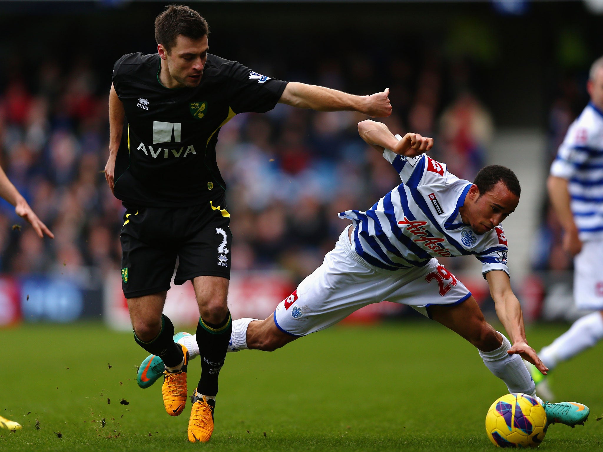 Andros Townsend of Queens Park Rangers battles for the ball with Russell Martin of Norwich City