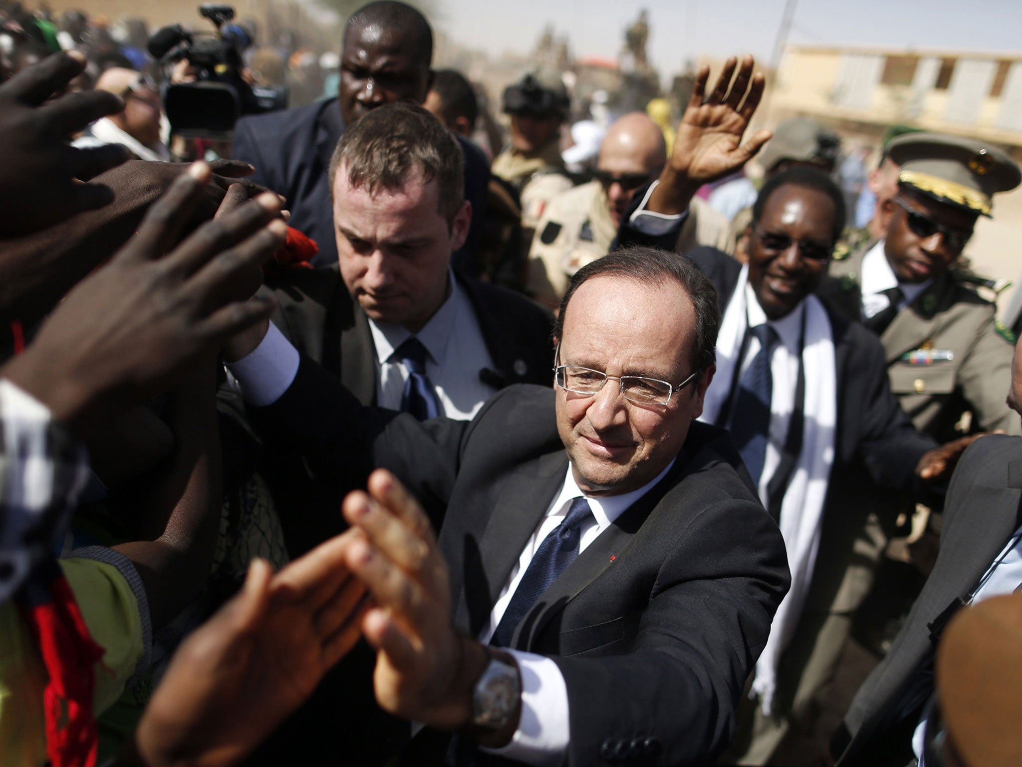 Warm welcome: François Hollande is mobbed by crowds in Timbuktu