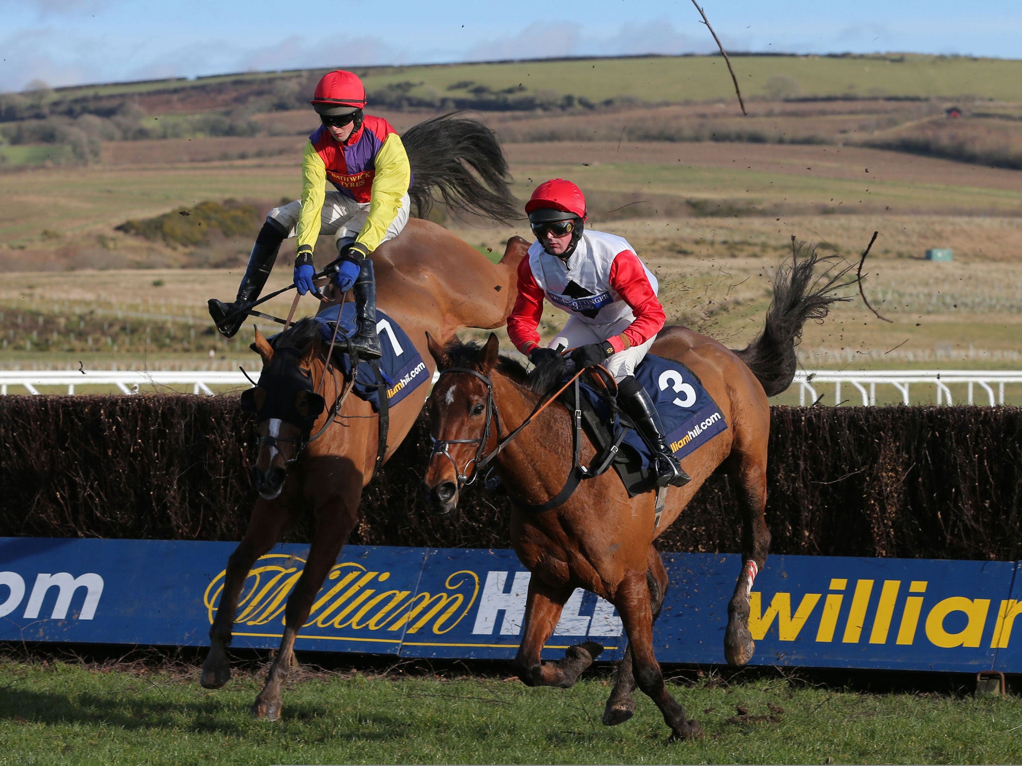 Jump lead: Nico de Boinville (right) on Carruthers moves ahead of Shaking Hands to win the West Wales National