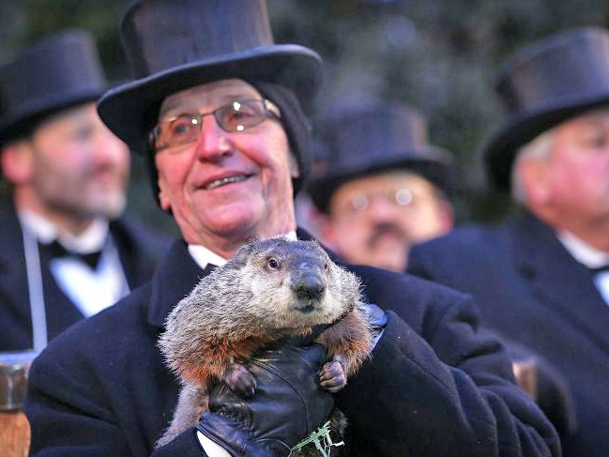 Co-handler Ron Ploucha holds Phil, the weather prognosticating groundhog during the Groundhog Day celebration at Gobblers Knob in Punxsutawney, Pennsylvania, USA