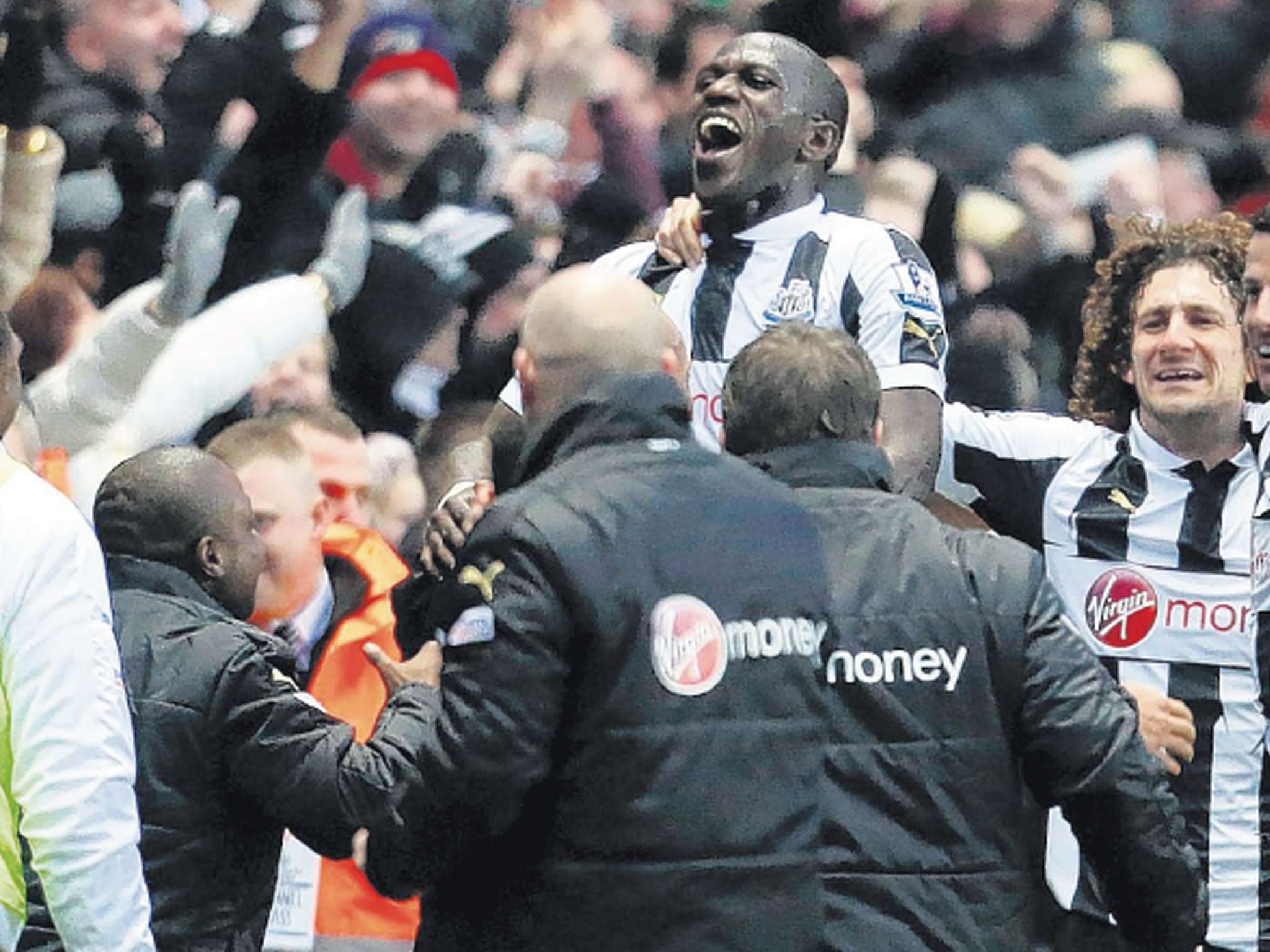 Moussa Sissoko is mobbed by his Newcastle team-mates on Saturday