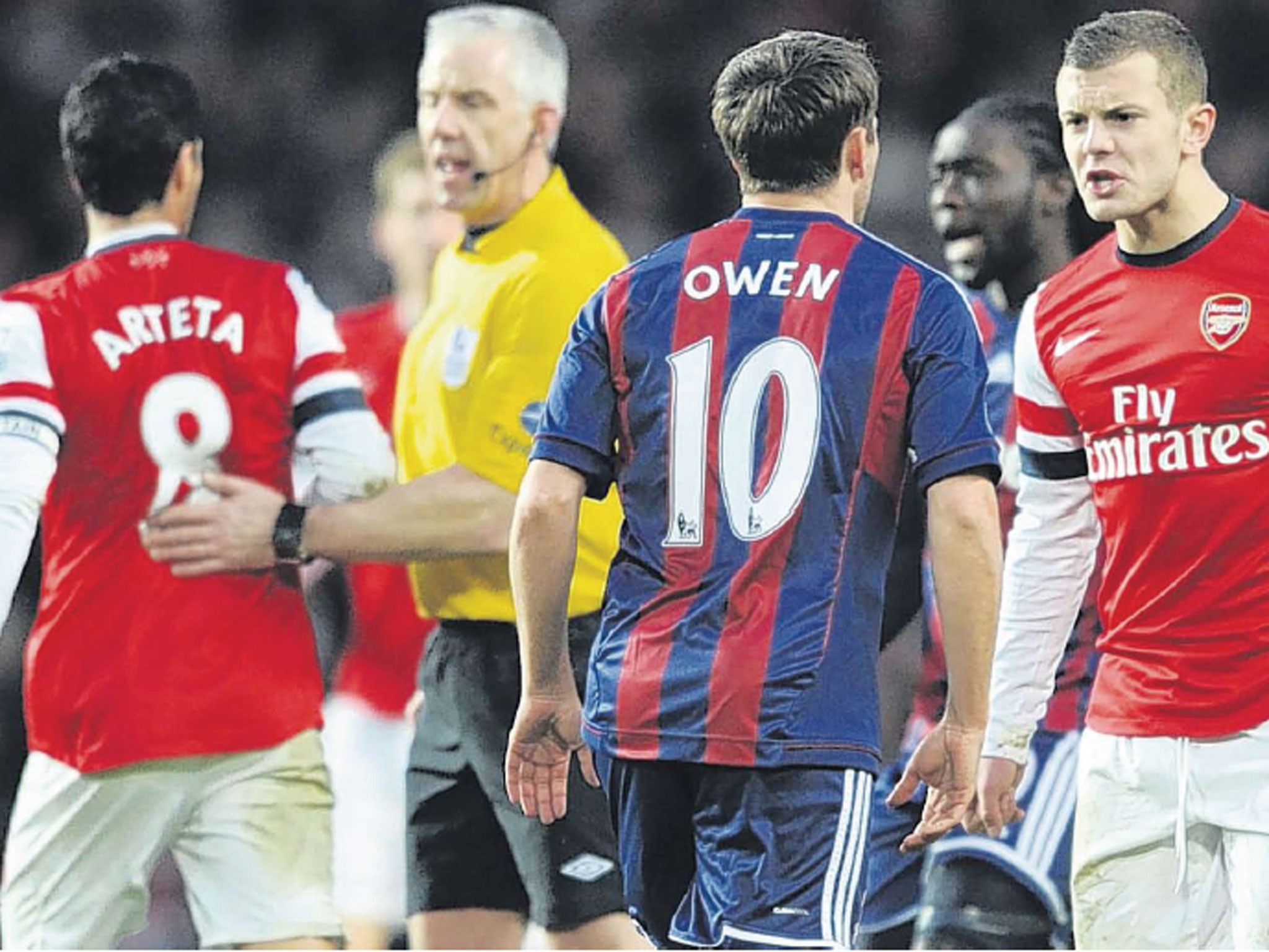 Arsenal’s Jack Wilshere clashes with Michael Owen