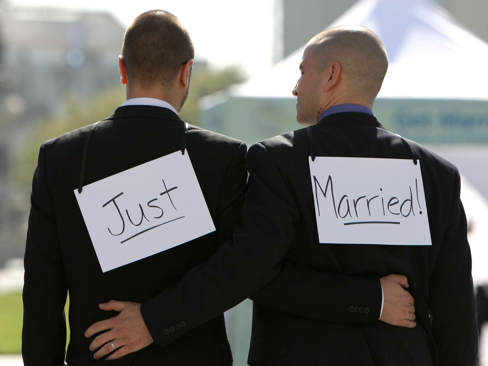 Same-sex couple Ariel Owens (R) and his spouse Joseph Barham walk arm in arm after they were married at San Francisco City Hall June 17, 2008 in San Francisco, California.