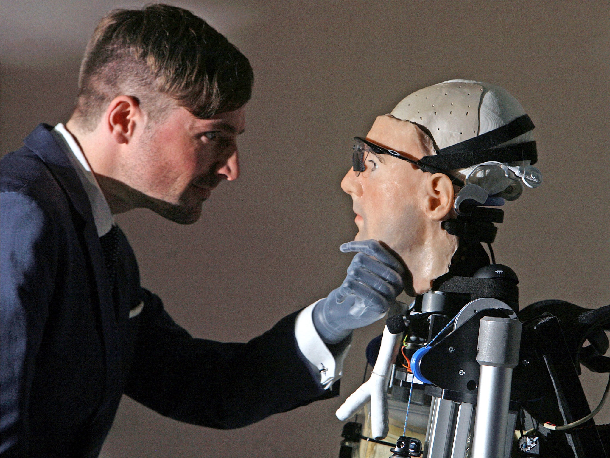 Documentary maker Bertolt Meyer (who has a bionic hand) is pictured examining 'Rex'