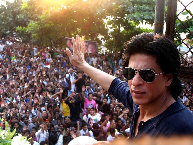 Indian Bollywood actor Shah Rukh Khan waves to fans and well-wishers gathered outside his residence for his 46th birthday in Mumbai on November 2, 2011.
