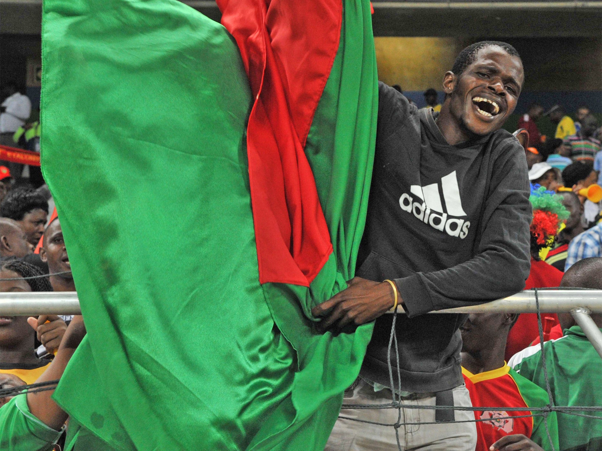 A Burkina-Faso supporter celebrates following their shootout victory