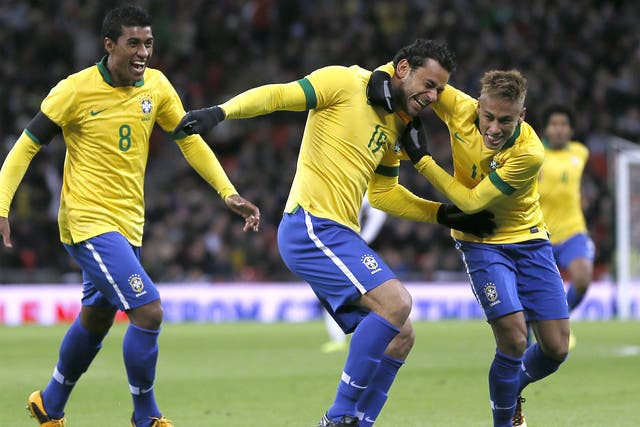 Fred (centre) celebrates his goal with Neymar (right) and Paulinho