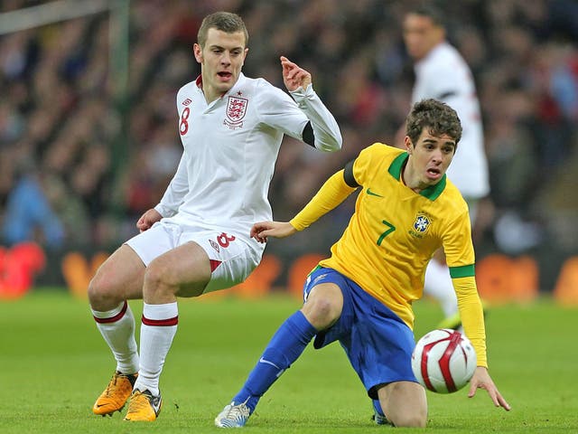 Jack Wilshere (left) and Oscar tussle for the ball at Wembley last night