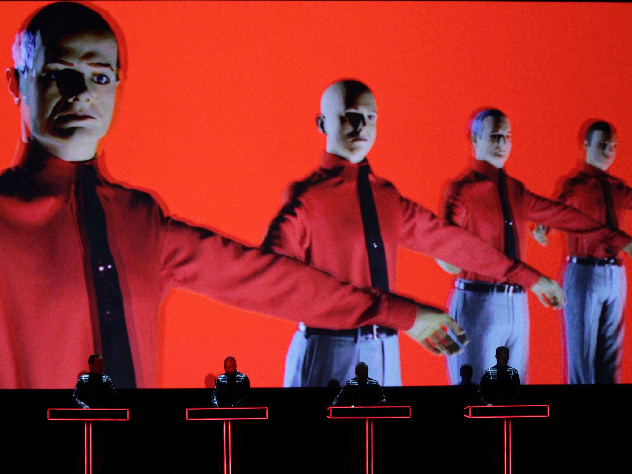 German electronic-music pioneers Kraftwerk perform in the Turbine Hall of Tate Modern against a giant backdrop