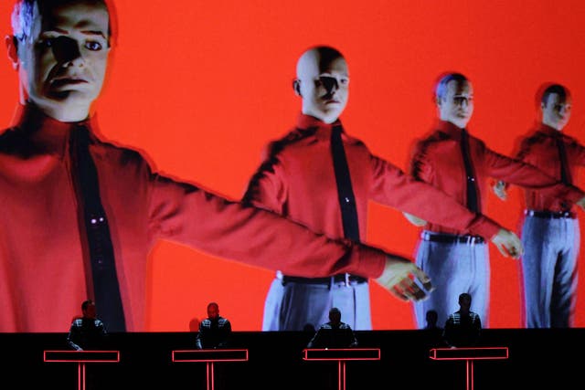 German electronic-music pioneers Kraftwerk perform in the Turbine Hall of Tate Modern against a giant backdrop