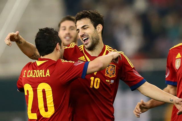 Cesc Fabrega is congratulated by Santi Cazorla as Spain beat Uruguay