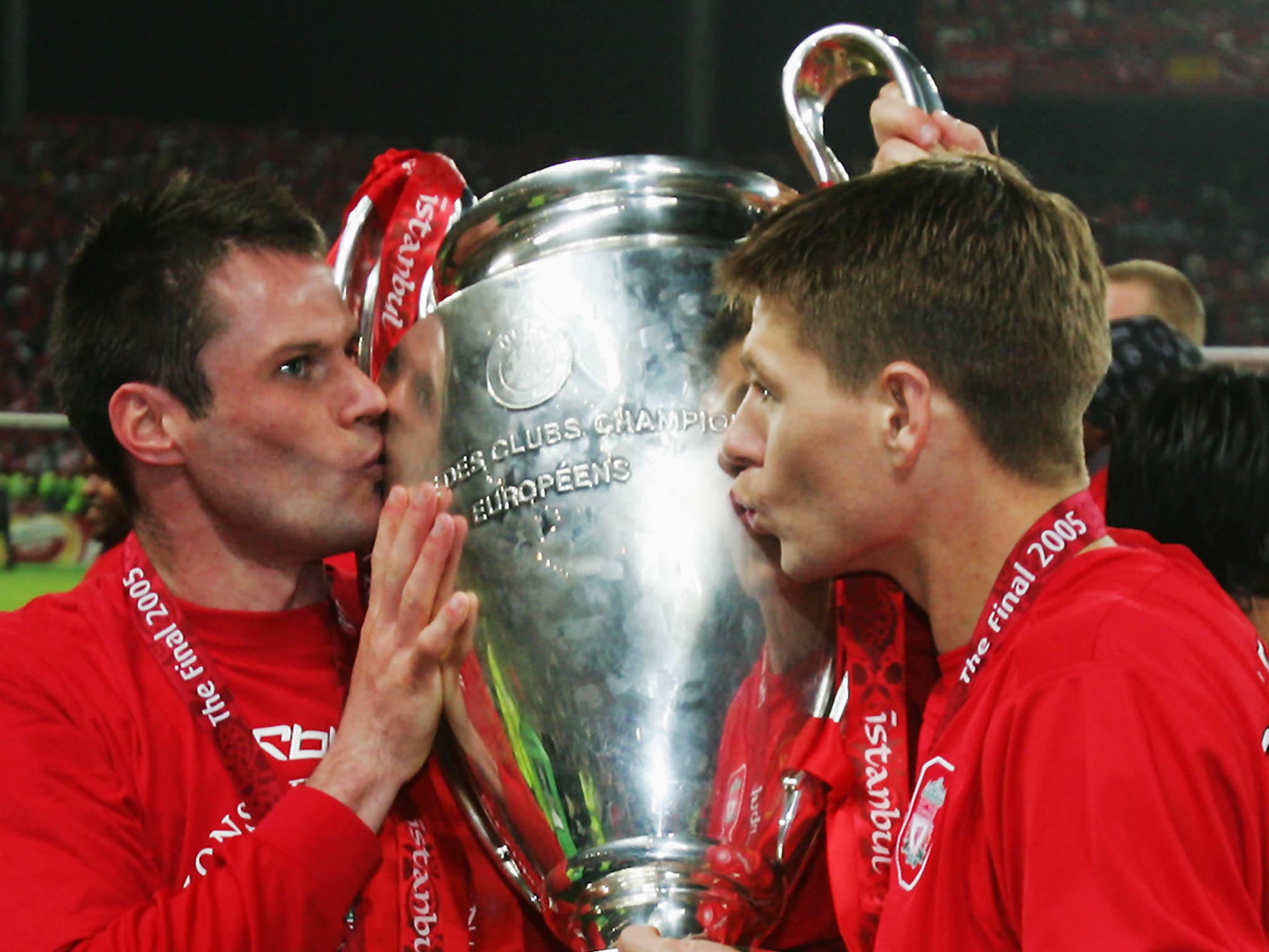 Jamie Carragher kisses the Champions League trophy alongside Steven Gerrard after the 2005 final