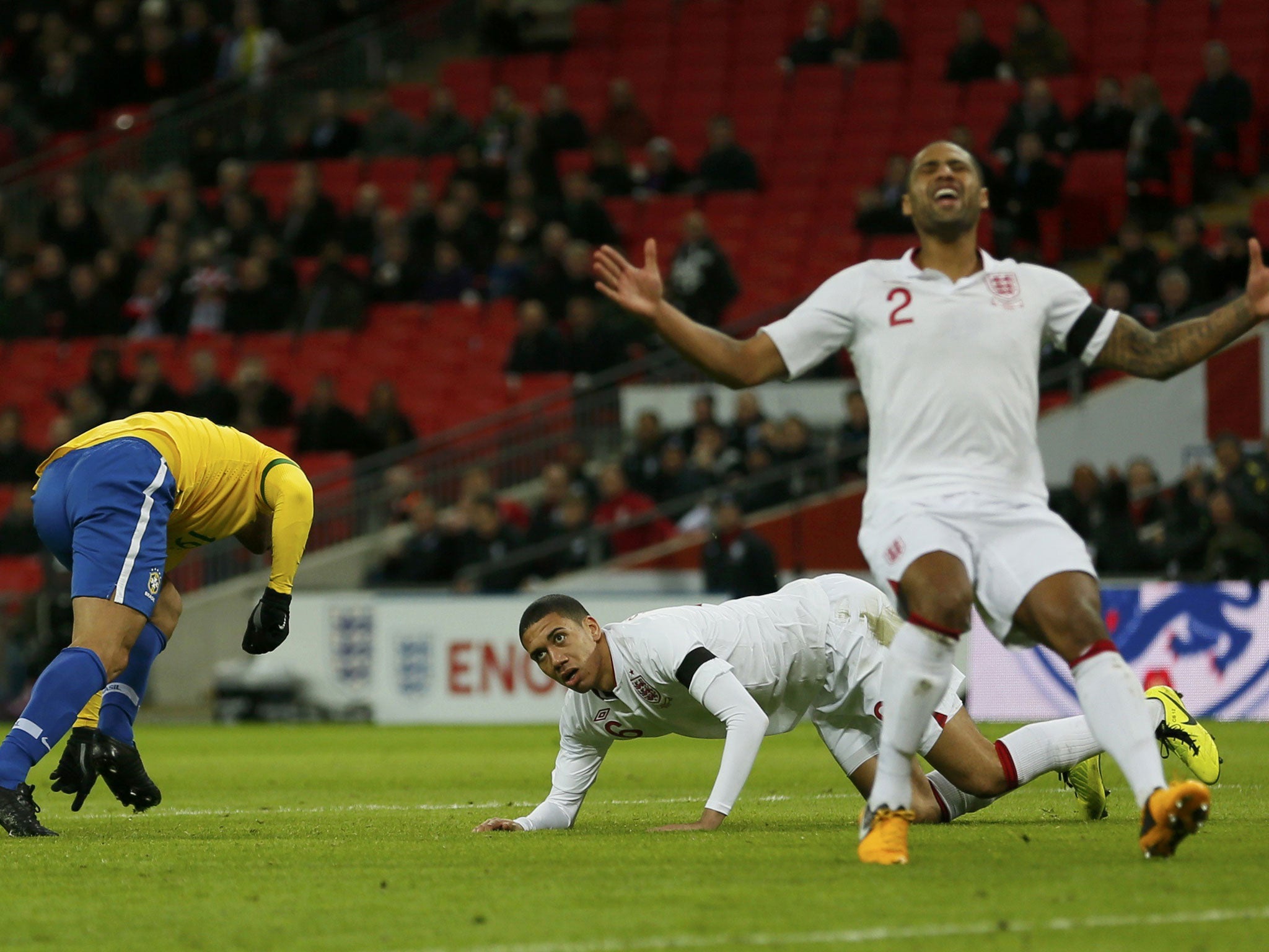 Glen Johnson and Chris Smalling (centre) react after Fred (left) scores Brazil’s goal at Wembley