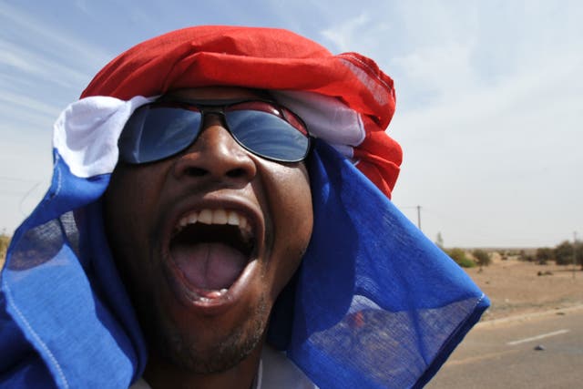 A man in Ansongo on January 29, 2013 cheers the anticipated arrival of troops from Niger.