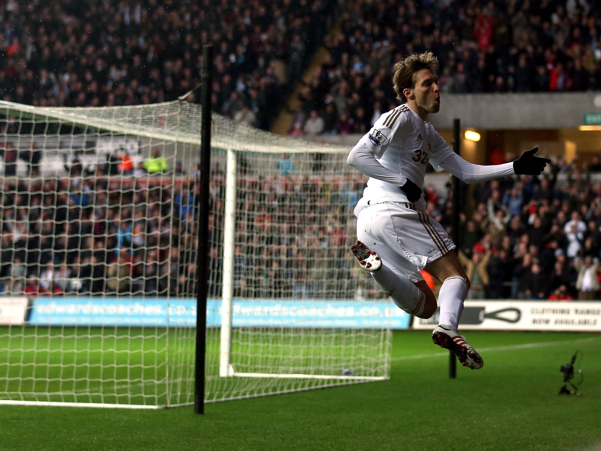 Swansea's Michu celebrates one of his two goals over QPR