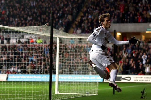 Swansea's Michu celebrates one of his two goals over QPR
