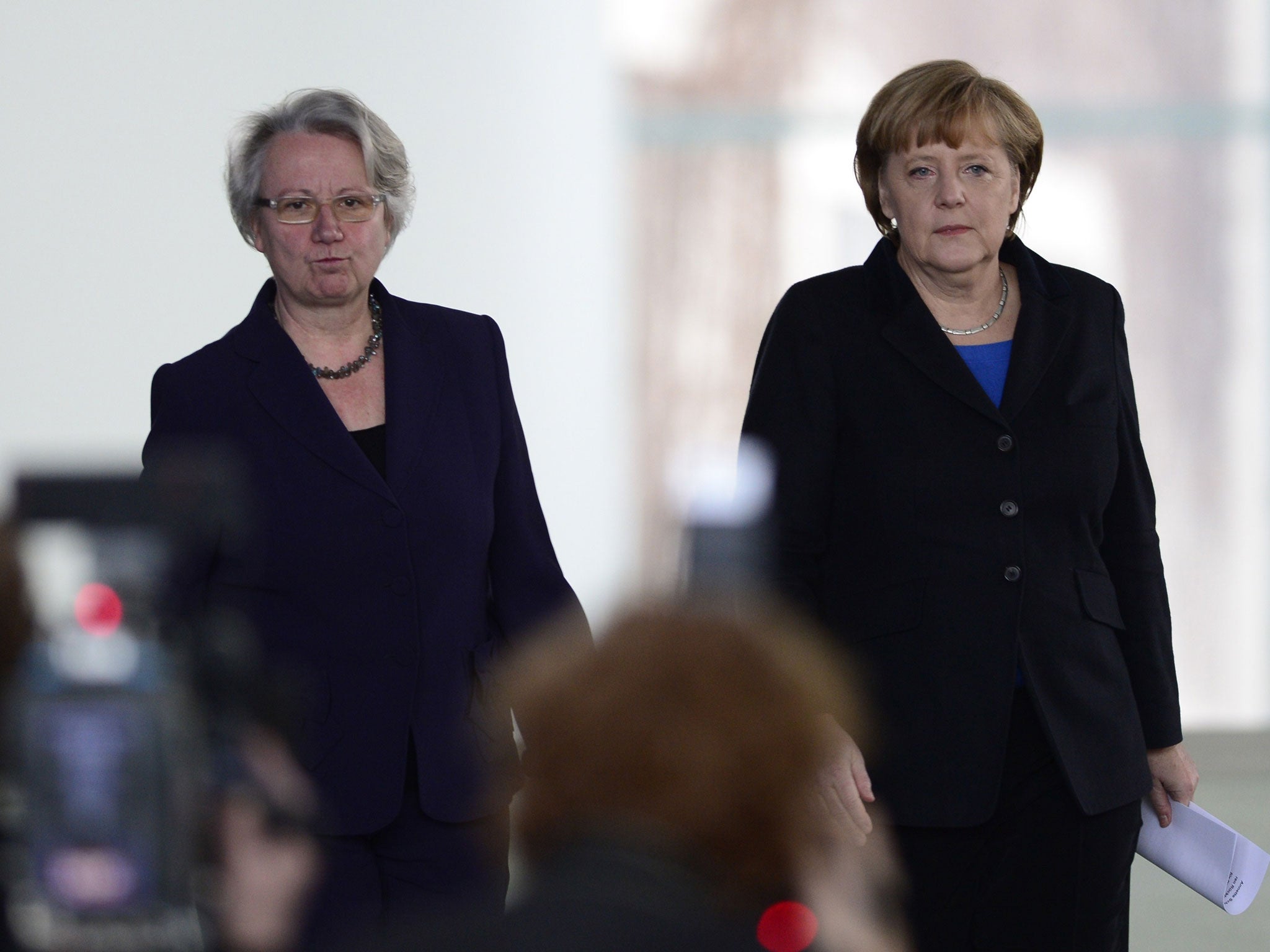 Parting shot: Annette Schavan, left, with Angela Merkel, arrives at a press conference to announce her resignation