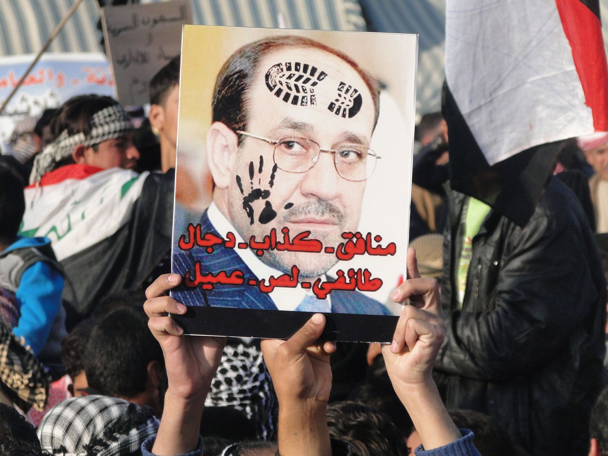 Hate figure: Sunni protesters in Anbar province with a poster of Nouri al-Maliki