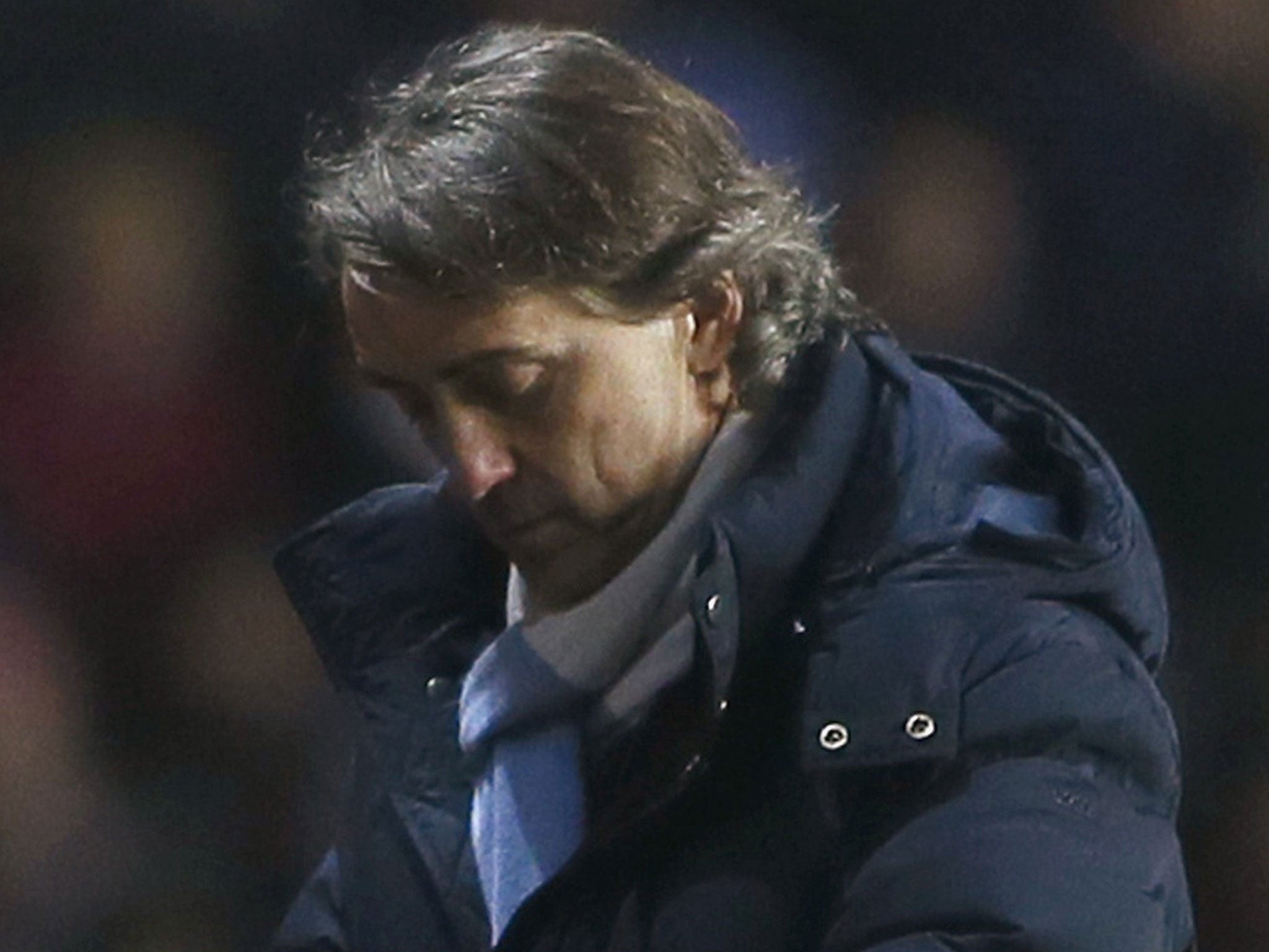 Roberto Mancini admitted that Man City's chances of retaining their title were low and may disappear altogether if Man United win at home to Everton