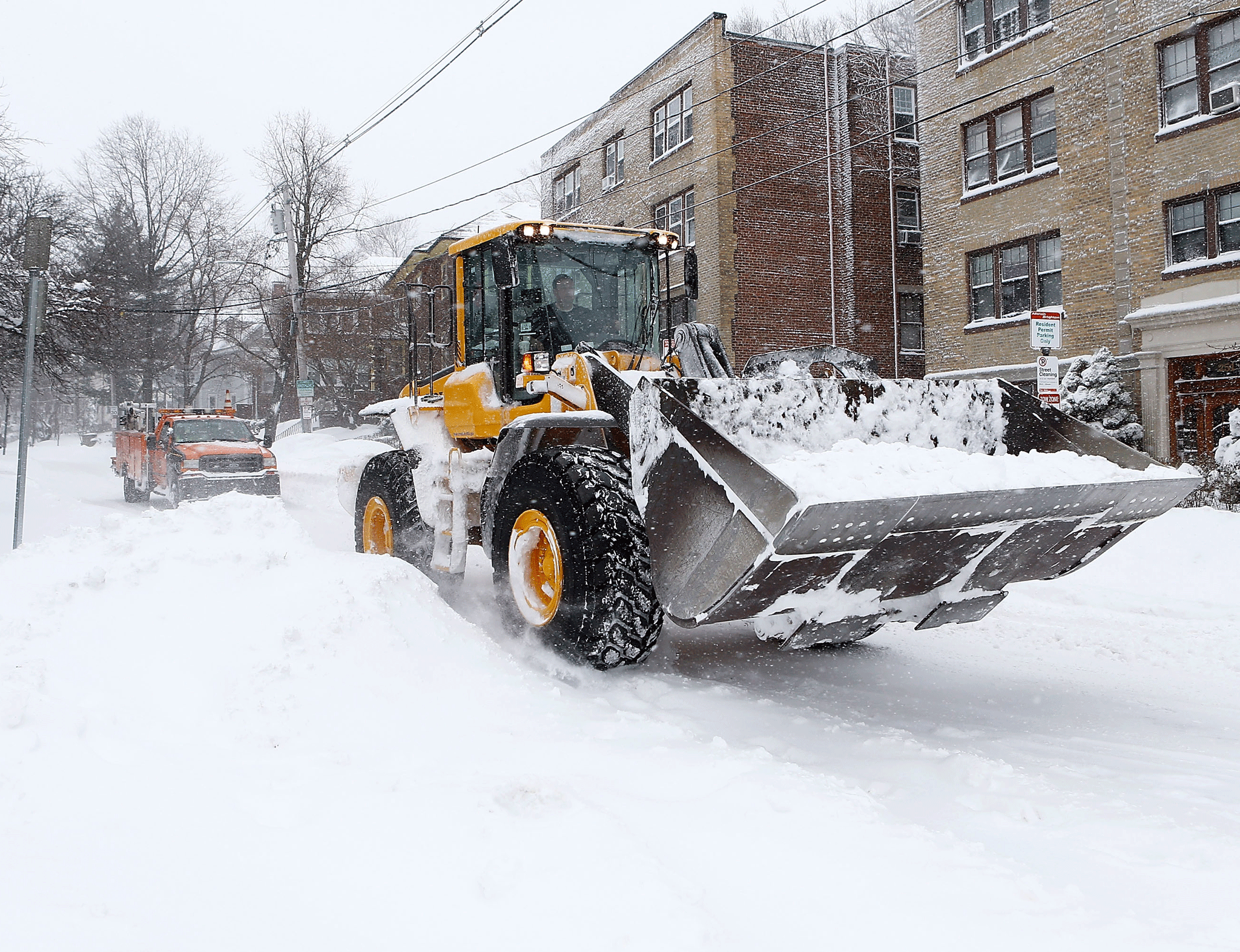 A digger in Boston, Massachusets, clears snow from the treacherous streets