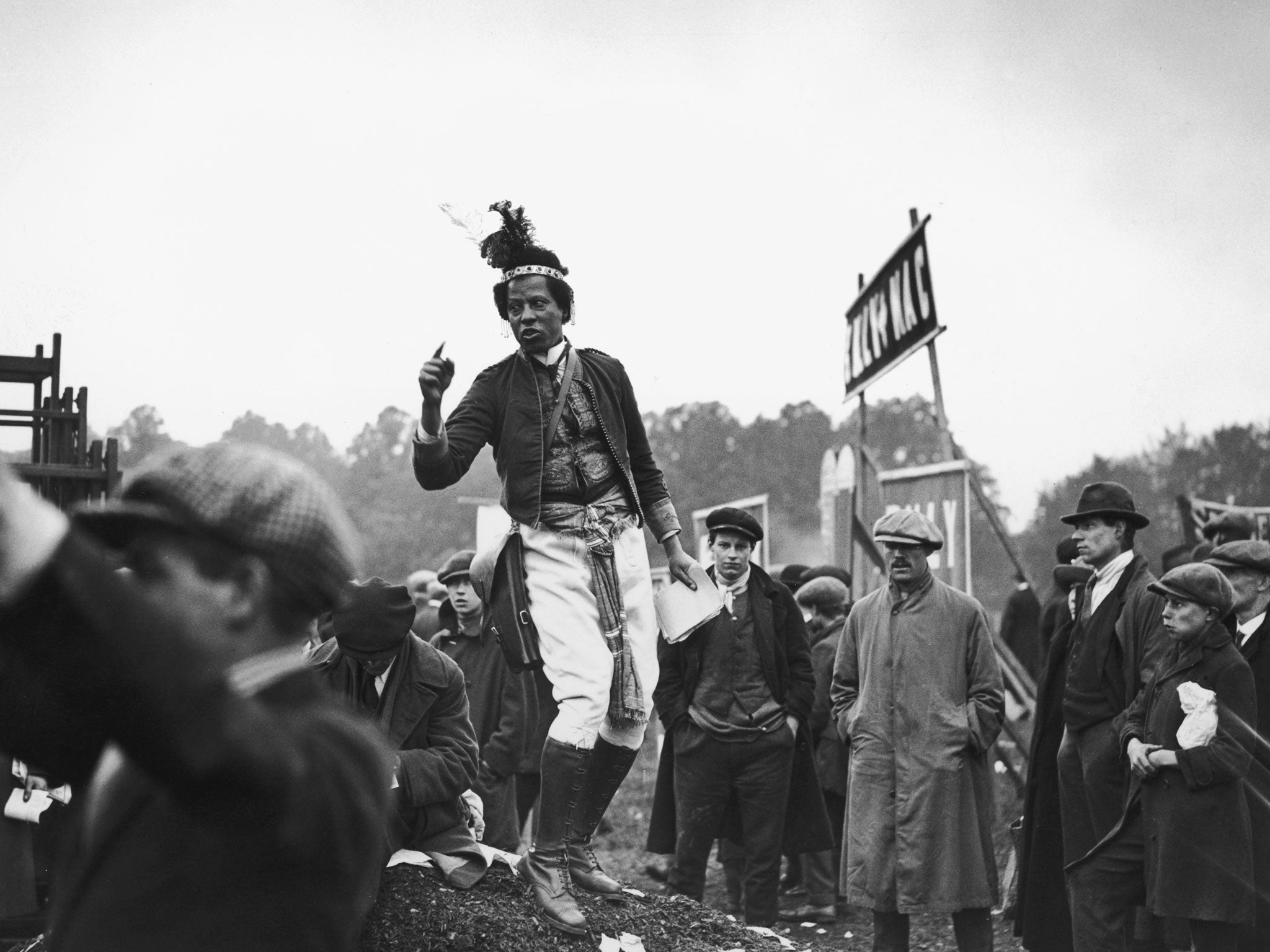 West Indian-born horse racing tipster Ras Prince Monolulu (1881 - 1965, real name Peter Carl Mackay), at the derby, Epsom, 1923. Monolulu frequently featured in newsreel broadcast of the time.