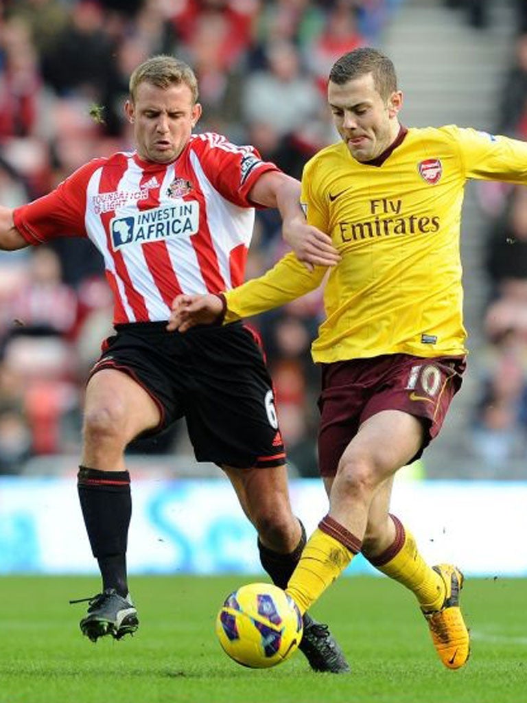 Jack Wilshere holds off the advances of Lee Cattermole on Saturday