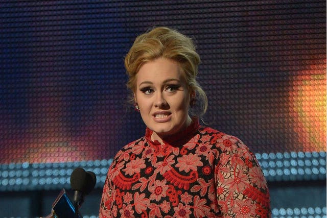 Adele receives the Grammy for best pop solo performance