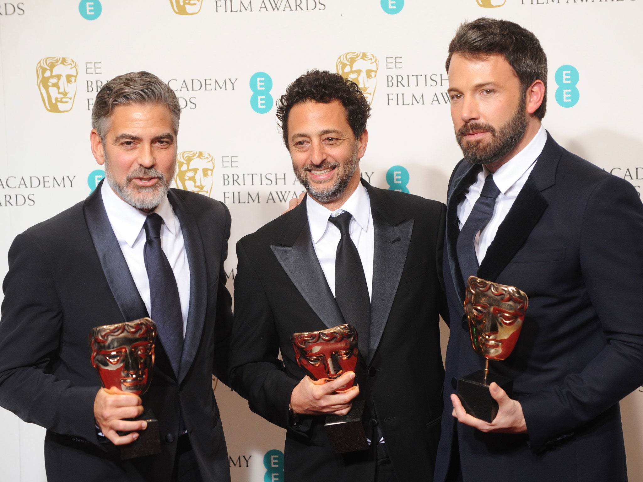 George Clooney, Grant Heslov and Ben Affleck, winners of the Best Film award for 'Argo', pose in the press room at the EE British Academy Film Awards at The Royal Opera House on February 10, 2013 in London, England.