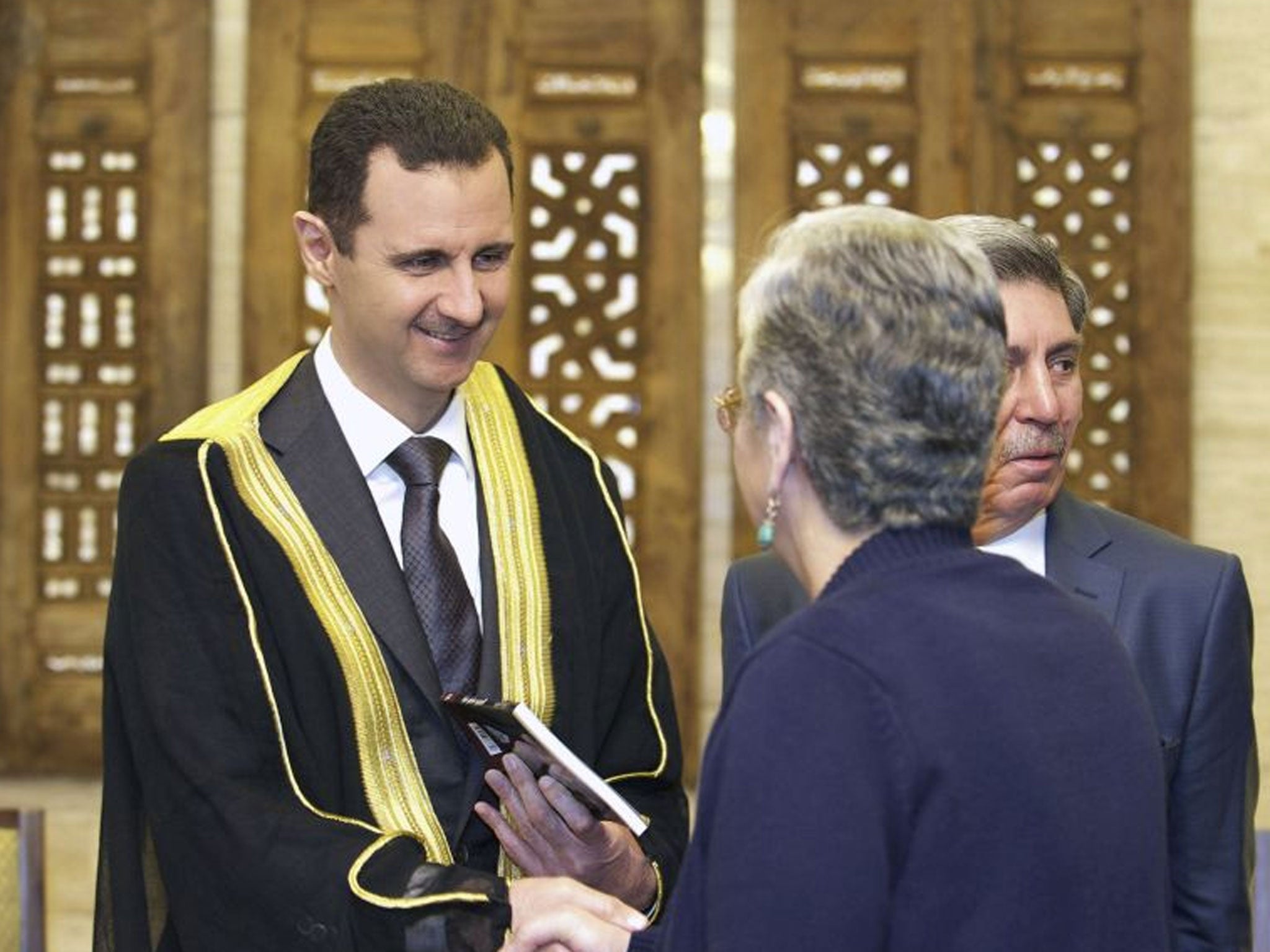 Syria President Bashar al-Assad greets a delegation of political supporters in Damascus