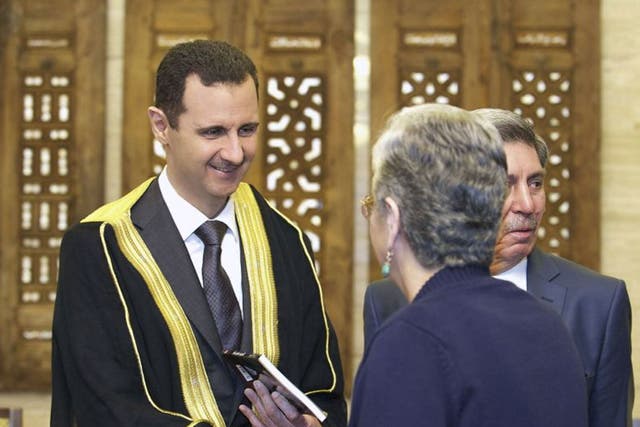 Syria President Bashar al-Assad greets a delegation of political supporters in Damascus