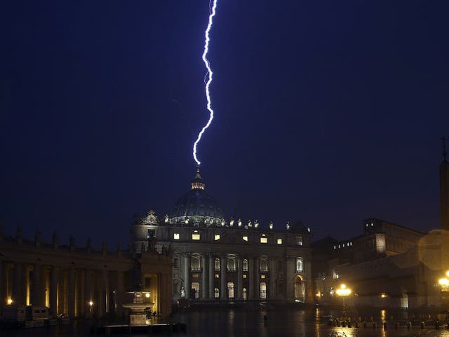 A flash of lightning is seen over St Peter's Basilica during a rainstorm last night