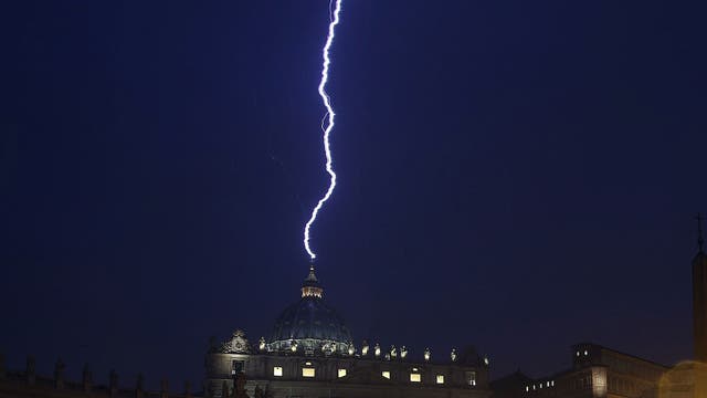 A flash of lightning is seen over St Peter's Basilica during a rainstorm last night