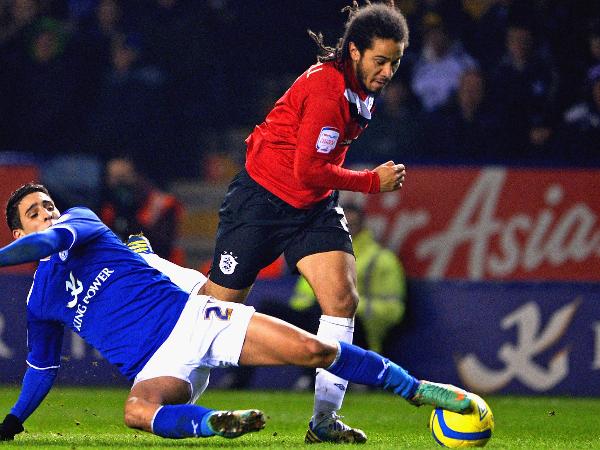 Huddersfield’s Sean Scannell rounds Anthony Knockaert of Leicester