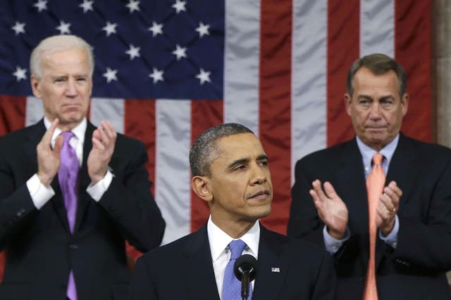 US House Speaker John Boehner (right) and Vice President Joe Biden (left) stand to applaud as President Barack Obama delivers his State of the Union speech