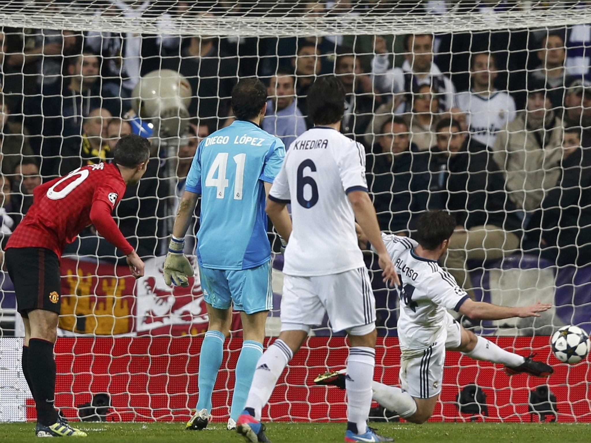 Robin Van Persie can only watch in vain as Xabi Alonso clears his mis-hit effort off the line last night