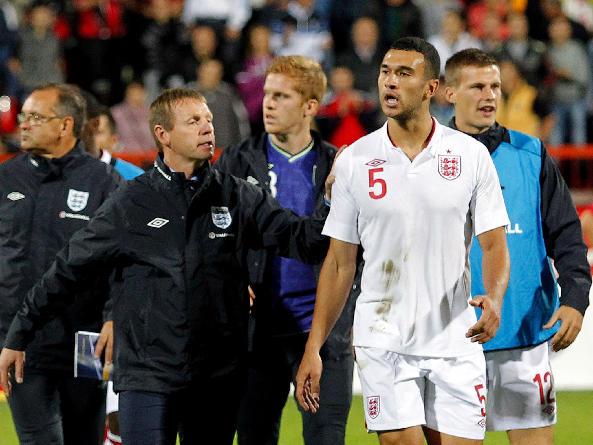 Steven Caulker (right) is led off after the game in Krusevac