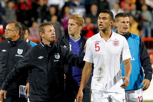 Steven Caulker (right) is led off  after the game in Krusevac