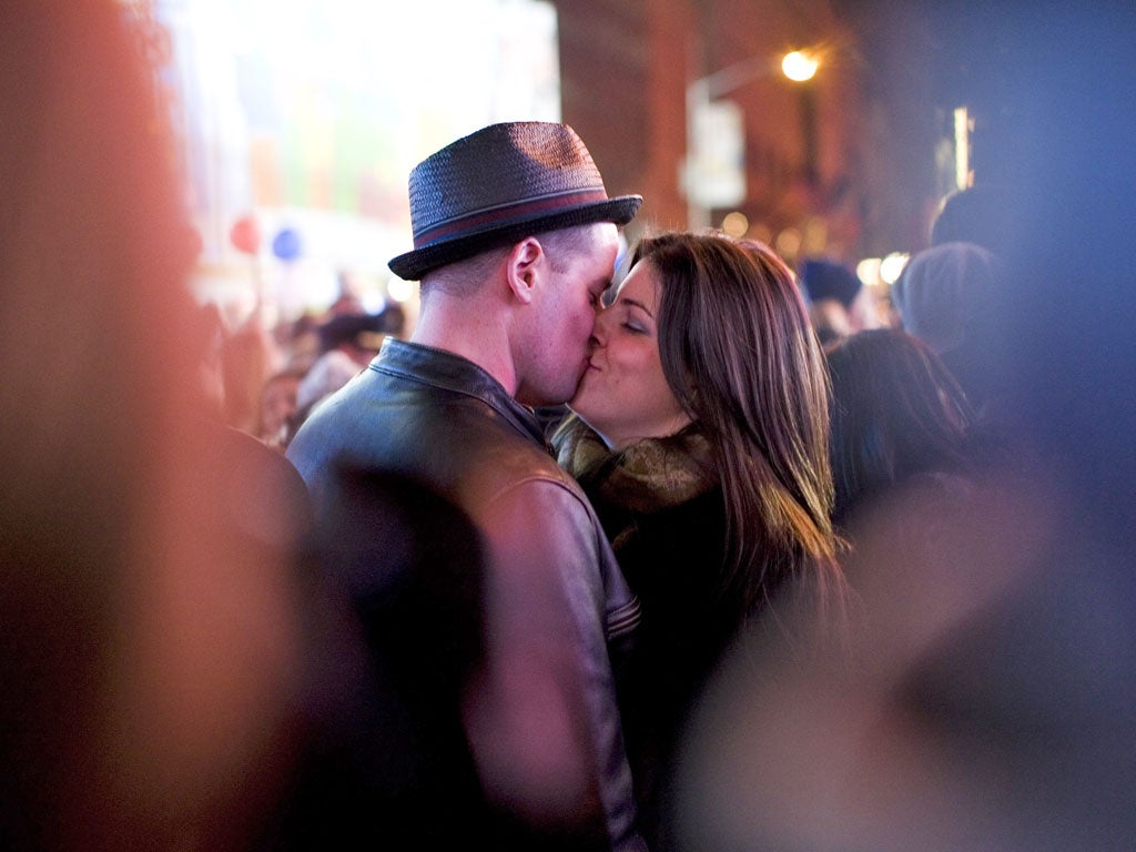 A couple kisses in Times Square, New York